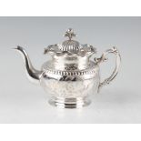 A late 19th/early 20th Century Chinese export silver teapot, engraved to body with floral and