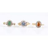 Three hallmarked 9ct yellow gold gemstone set cluster rings, to include sapphire and emerald all