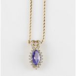A tanzanite and diamond pendant, set with a central marquise cut tanzanite, measuring approx.