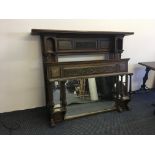 An oak fire surround with fluted columns to side, carved panel back, with a separate over mantle