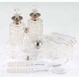 Four hallmarked silver topped dressing table perfume bottles, together with a pair of cut glass