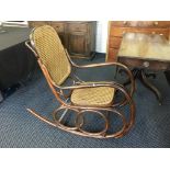 A bentwood framed rocking chair with bergere back and seat.