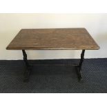 Three mahogany topped cast iron based, one square, two oblong pub tables.