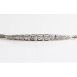 A diamond line bracelet, set with thirteen graduated round brilliant cut diamonds in square