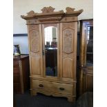 A satinwood Edwardian mirror front wardrobe with carved panel decoration.