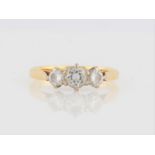 A hallmarked 18ct yellow gold three stone diamond ring, set with three graduated round brilliant cut