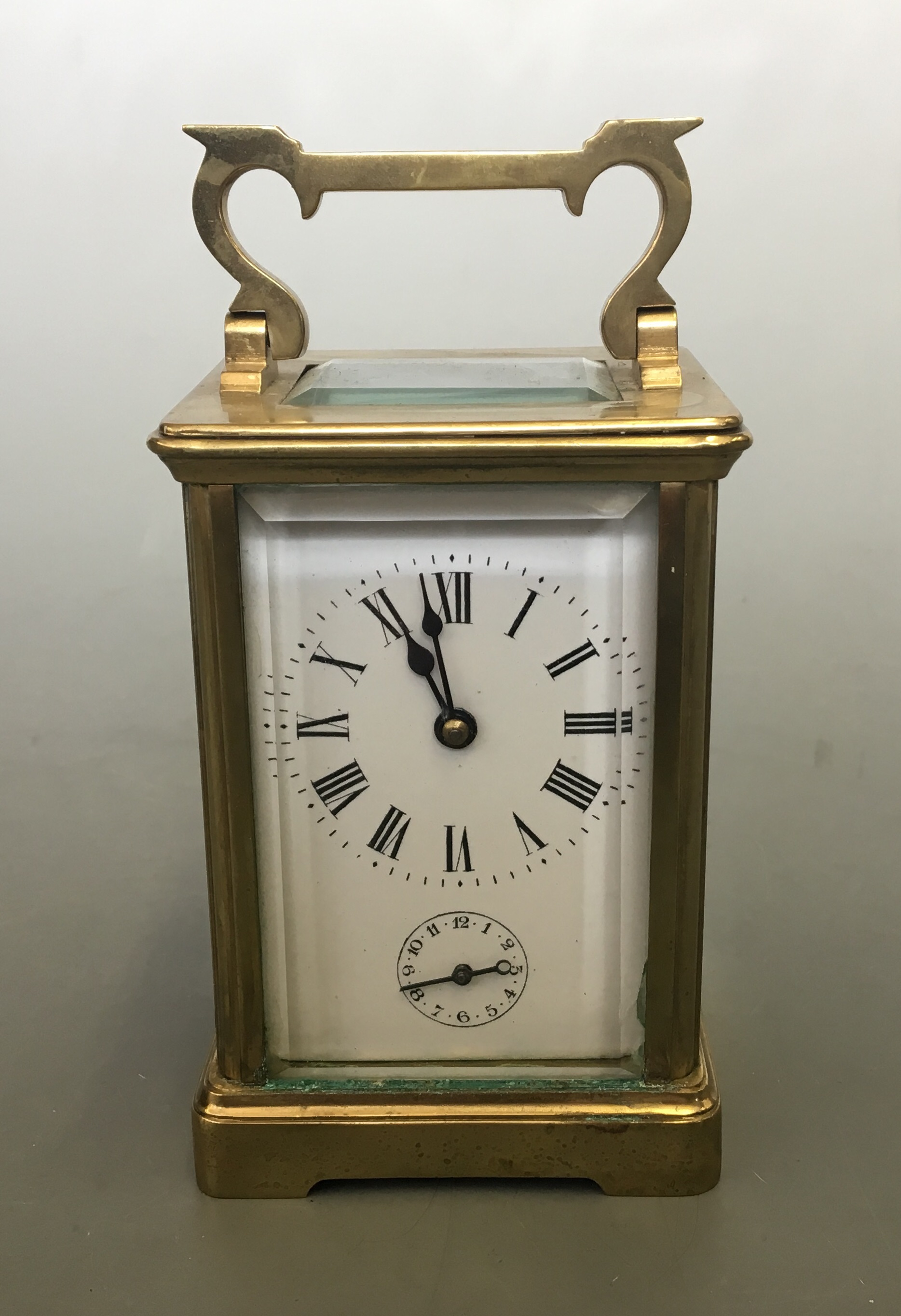 A brass five glass panelled enamelled face carriage clock.