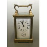 A brass five glass panelled enamelled face carriage clock.