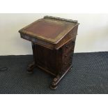 A walnut Victorian four drawer Davenport with brass gallery to top.