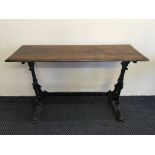 One mahogany topped cast iron based oblong pub table with Mitchell’s & Butlers Ltd to base.