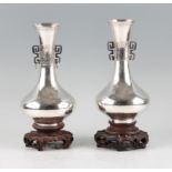 A pair of late 19th/early 20th Century Chinese export silver vases by Luenwo, engraved with