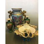 A large blue two gilded handled floral vase, with a Sevres style Tazza with cherub decoration and