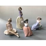 Four Nao figurines including seated female with bird, ballet dancer and small girl.