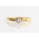 A hallmarked 18ct yellow gold diamond ring, set with a principal round brilliant cut diamond,