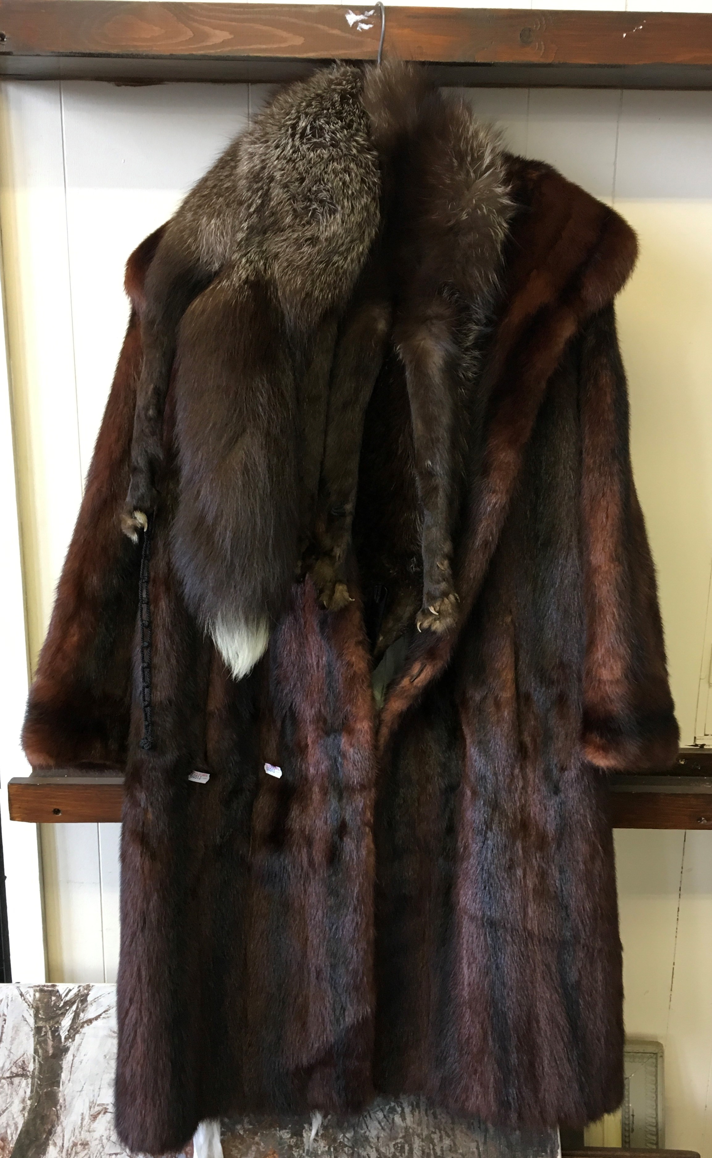 A brown ladies fur coat together with an Arctic Fox fur scarf.