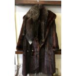 A brown ladies fur coat together with an Arctic Fox fur scarf.