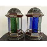 Two stained glass lanterns in blue, green and red, with pierced detail top and bottom, height 34cm.