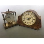 An A.H. Clarke Birmingham mantel clock with Kundo electronic mantel clock.