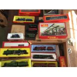 A collection of model railway items including thirteen Tri-ang locomotives, a large station, various