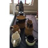 Six various jugs to include three salt glazed jugs, together with a three handled salt glazed