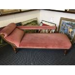 An Edwardian oak chaise lounges with dusty pink upholstery