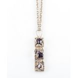 A Danish amethyst pendant, the organic rectangular design set with three tumbled amethyst pieces,