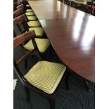 A Georgian style, reproduction, four sectioned mahogany dining table, with 16 dining chairs and two