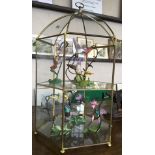 A set of six Franklin Mint figures of humming birds in glass and brass six sided display stand