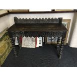 An oak hall table with bobbin turn legs.