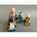 Two Japanese porcelain faced dolls of children together with a blue cloisonne small vase, height