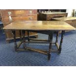 A 18th Century oak, gate legged, peg joint drop leaf table with turned columns