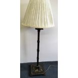 A black and gold painted standard lamp with Japanese scenes and cream shade.