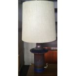 A blue and red soholm stento lamp with beige shade.