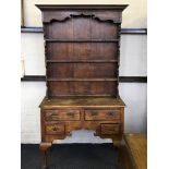 An early 19th Century, Georgian style oak narrow kitchen dresser with plate wrack and two long and