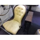 A Victorian button backed nursing chair with yellow upholstery, together with a drop leaf table