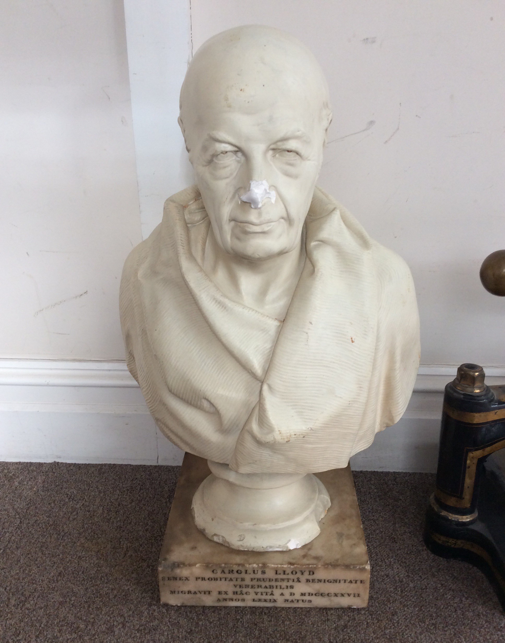 A large white plaster bust of Carolus Lloyd with marble base inscribed "Senex Probitate Prudentia