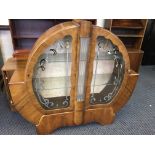 A walnut round display cabinet with glass rod to centre