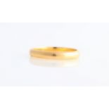 A wedding band, stamped 22ct, ring size K.