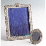 An Edwardian silver fronted photograph frame, the rectangular shape featuring repousse gadrooned