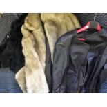 A selection of fur coats and brown leather jackets