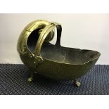 An arts and craft brass coal bucket with shell design
