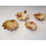 A group of four Royal Worcester clam shaped bowls with floral designs, three with puce marks of base