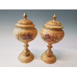 A pair of Royal Worcester goblet with pierced lids and painted floral scenes, model number 1813