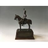 A resin figure of C. B. Attery riding horse, on wooden plinth with brass plaques, total height 41.5