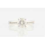 A hallmarked 9ct white gold moissanite ring, set with a principal round brilliant cut moissanite,