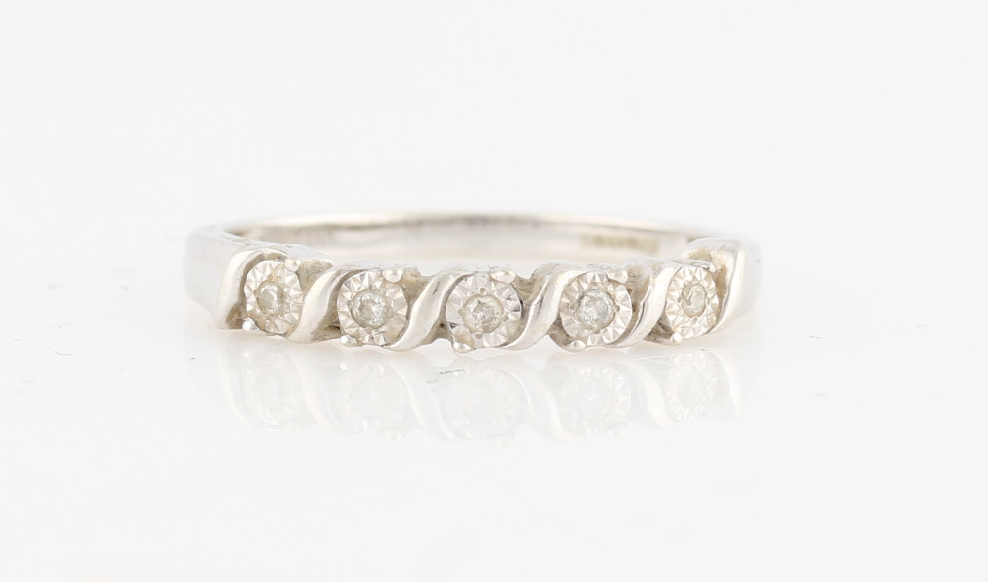 A hallmarked 9ct white gold diamond half eternity ring, set with five round brilliant cut diamond