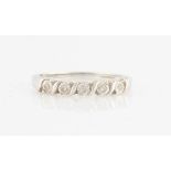 A hallmarked 9ct white gold diamond half eternity ring, set with five round brilliant cut diamond