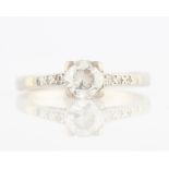 A diamond ring, set with a principal round brilliant cut diamond, measuring approx. 0.75ct, each