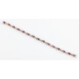 A hallmarked 9ct yellow gold amethyst and diamond bracelet, set with fourteen oval cut amethysts and