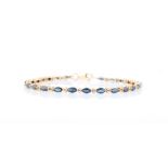 A sapphire and diamond bracelet, set with 24 marquise cut sapphires, separated by round brilliant